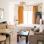 Livingroom and bedroom with white walls and yellow curtains