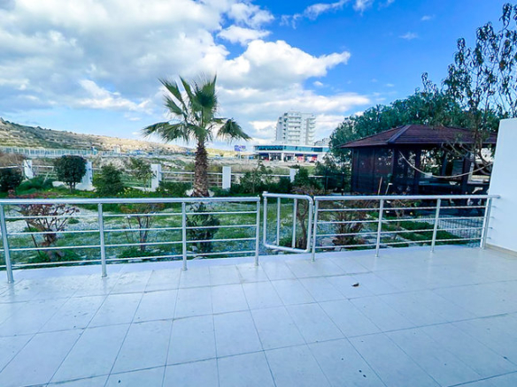 Private garden of 3-bedroom villa with palm trees and greenery at Caesar Beach