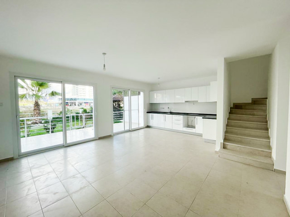 Villa entrance and modern kitchen with staircase to upper floor in Boaz
