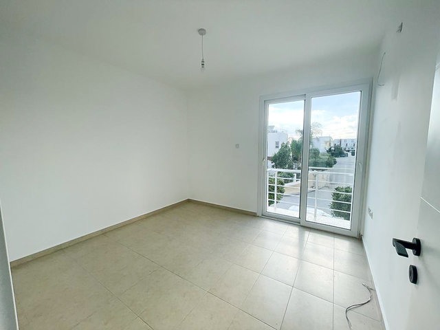 Bedroom in 3-bedroom villa at Caesar Beach with balcony door and natural light
