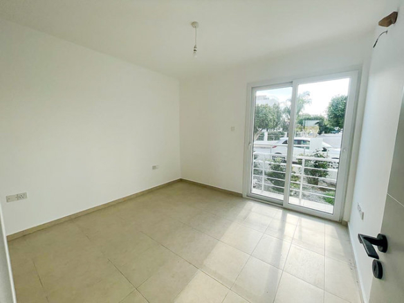 Bedroom in 3-bedroom villa at Caesar Beach with balcony door and natural light