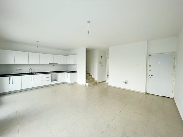 Villa entrance and modern kitchen with staircase to upper floor in Boaz