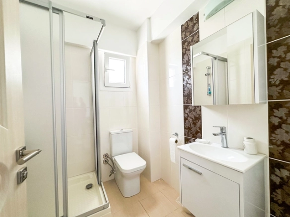 Modern 2-bedroom apartment in Long Beach, North Cyprus with sea views, fully furnished interiors, fitted kitchen, bright living room, two cozy bedrooms, and a private balcony overlooking the Mediterranean.