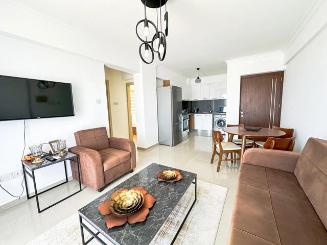 Modern 2-bedroom apartment in Long Beach, North Cyprus with sea views, fully furnished interiors, fitted kitchen, bright living room, two cozy bedrooms, and a private balcony overlooking the Mediterranean.