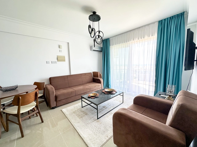 Modern 2-bedroom apartment in Long Beach, North Cyprus with sea views, fully furnished interiors, fitted kitchen, bright living room, two cozy bedrooms, and a private balcony overlooking the Mediterranean.