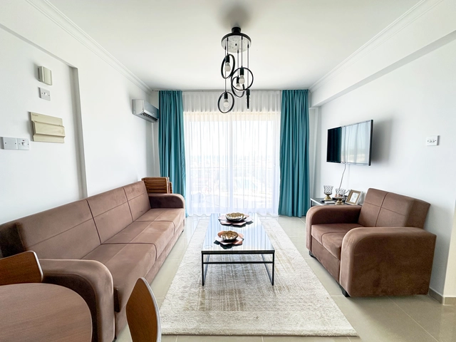 Modern 2-bedroom apartment in Long Beach, North Cyprus with sea views, fully furnished interiors, fitted kitchen, bright living room, two cozy bedrooms, and a private balcony overlooking the Mediterranean.