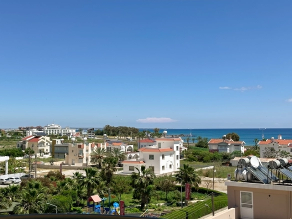 Modern 2-bedroom apartment in Long Beach, North Cyprus with sea views, fully furnished interiors, fitted kitchen, bright living room, two cozy bedrooms, and a private balcony overlooking the Mediterranean.