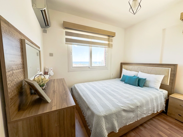 Modern 2-bedroom apartment in Long Beach, North Cyprus with sea views, fully furnished interiors, fitted kitchen, bright living room, two cozy bedrooms, and a private balcony overlooking the Mediterranean.