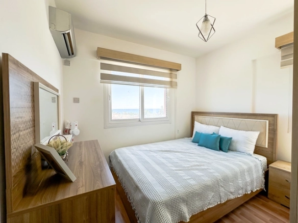 Modern 2-bedroom apartment in Long Beach, North Cyprus with sea views, fully furnished interiors, fitted kitchen, bright living room, two cozy bedrooms, and a private balcony overlooking the Mediterranean.