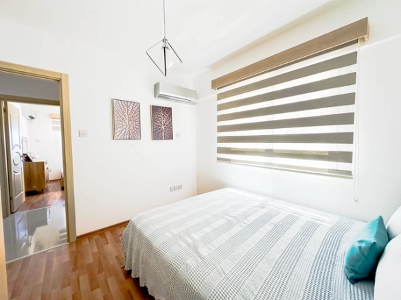 Modern 2-bedroom apartment in Long Beach, North Cyprus with sea views, fully furnished interiors, fitted kitchen, bright living room, two cozy bedrooms, and a private balcony overlooking the Mediterranean.