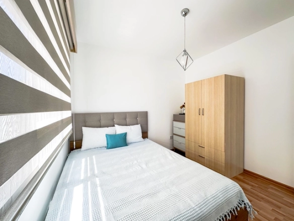 Modern 2-bedroom apartment in Long Beach, North Cyprus with sea views, fully furnished interiors, fitted kitchen, bright living room, two cozy bedrooms, and a private balcony overlooking the Mediterranean.