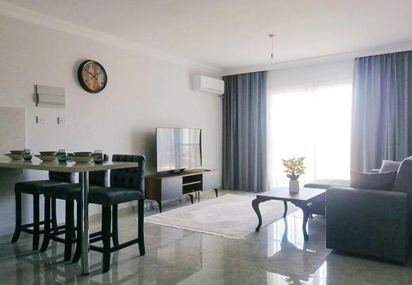 Fully furnished 1-bedroom apartment in Park Residence Long Beach with modern open-plan kitchen, bright living room, spacious balcony, and ready-to-move-in condition in North Cyprus