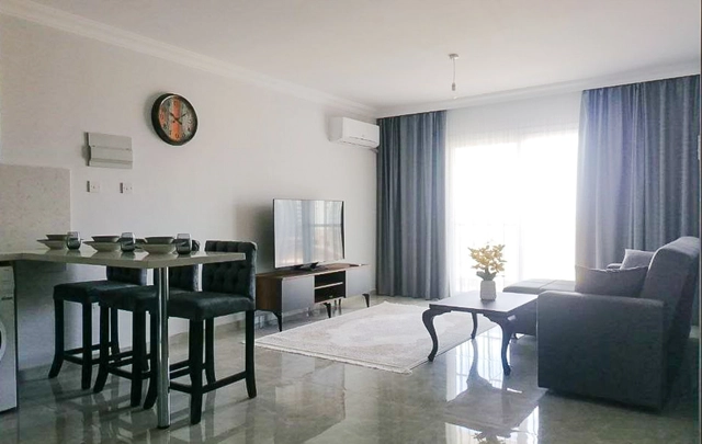 Fully furnished 1-bedroom apartment in Park Residence Long Beach with modern open-plan kitchen, bright living room, spacious balcony, and ready-to-move-in condition in North Cyprus