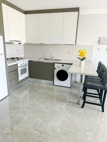 Fully furnished 1-bedroom apartment in Park Residence Long Beach with modern open-plan kitchen, bright living room, spacious balcony, and ready-to-move-in condition in North Cyprus
