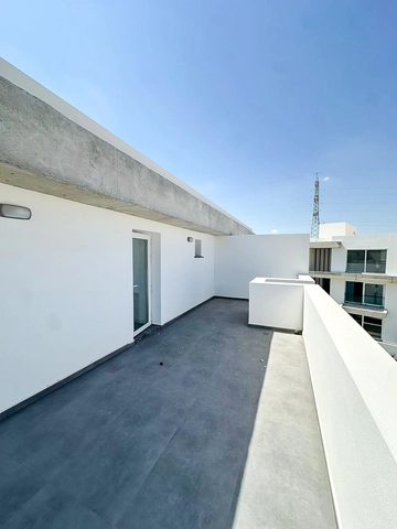 Loft townhouse apartment in Olive Court Yeni Boğaziçi with duplex layout, modern interior, large terrace, high ceilings, and bright open-plan living space in North Cyprus