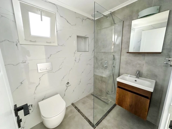 Loft townhouse apartment in Olive Court Yeni Boğaziçi with duplex layout, modern interior, large terrace, high ceilings, and bright open-plan living space in North Cyprus