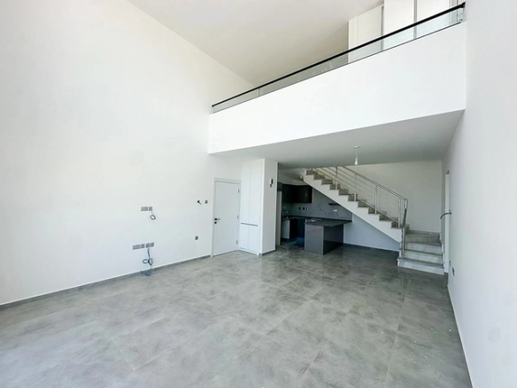 Loft townhouse apartment in Olive Court Yeni Boğaziçi with duplex layout, modern interior, large terrace, high ceilings, and bright open-plan living space in North Cyprus