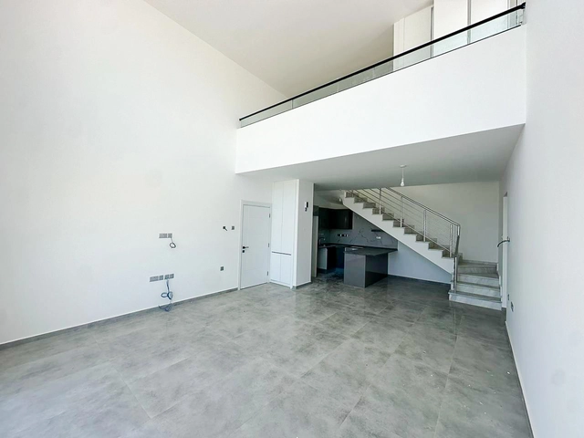 Loft townhouse apartment in Olive Court Yeni Boğaziçi with duplex layout, modern interior, large terrace, high ceilings, and bright open-plan living space in North Cyprus
