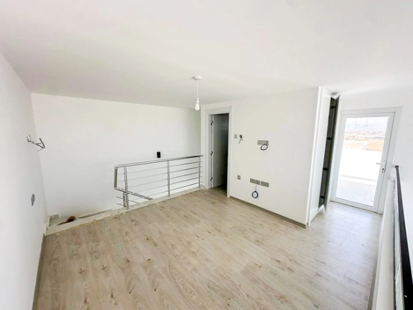 Loft townhouse apartment in Olive Court Yeni Boğaziçi with duplex layout, modern interior, large terrace, high ceilings, and bright open-plan living space in North Cyprus