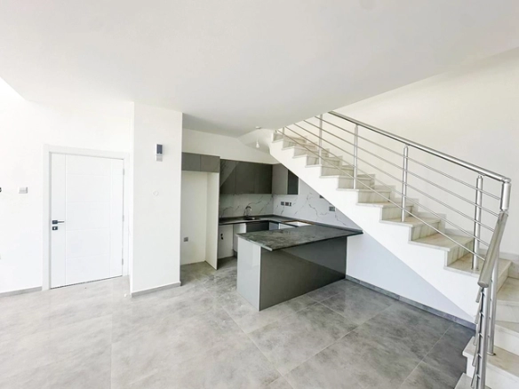 Loft townhouse apartment in Olive Court Yeni Boğaziçi with duplex layout, modern interior, large terrace, high ceilings, and bright open-plan living space in North Cyprus