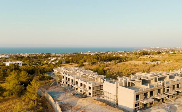 Modern townhouse Project in Lapta Kyrenia featuring stylish interior design, open-plan kitchen, spacious living area, and scenic mountain and pool views in North Cyprus.