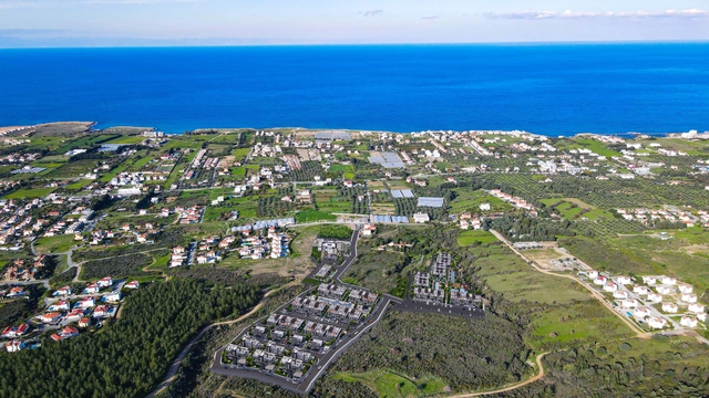 Modern 1-bedroom garden apartment in Spectra Project Lapta featuring stylish interior design, open-plan kitchen, spacious living area, and scenic mountain and pool views in North Cyprus.