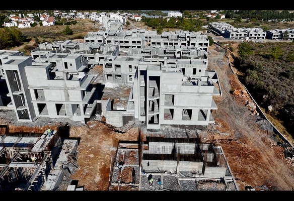 Modern 1-bedroom garden apartment in Spectra Project Lapta featuring stylish interior design, open-plan kitchen, spacious living area, and scenic mountain and pool views in North Cyprus.