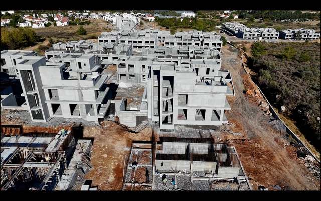 Modern 1-bedroom garden apartment in Spectra Project Lapta featuring stylish interior design, open-plan kitchen, spacious living area, and scenic mountain and pool views in North Cyprus.