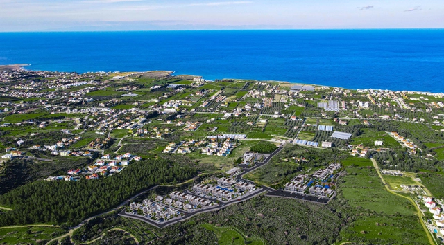 Modern 1-bedroom garden apartment in Spectra Project Lapta featuring stylish interior design, open-plan kitchen, spacious living area, and scenic mountain and pool views in North Cyprus.