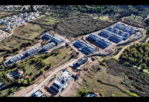 Modern 1-bedroom garden apartment in Spectra Project Lapta featuring stylish interior design, open-plan kitchen, spacious living area, and scenic mountain and pool views in North Cyprus.