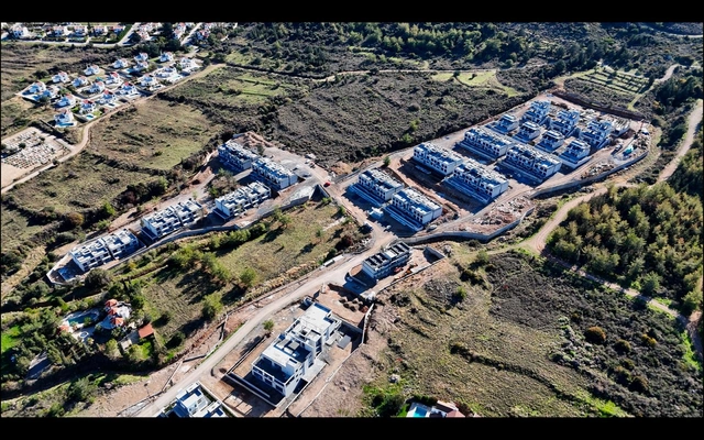 Modern 1-bedroom garden apartment in Spectra Project Lapta featuring stylish interior design, open-plan kitchen, spacious living area, and scenic mountain and pool views in North Cyprus.