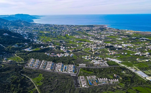 Modern 1-bedroom garden apartment in Spectra Project Lapta featuring stylish interior design, open-plan kitchen, spacious living area, and scenic mountain and pool views in North Cyprus.