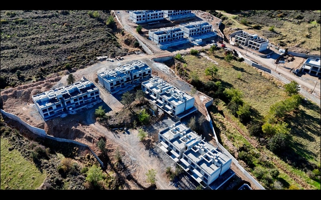 spectra drone (4).jpeg4 Modern 1-bedroom garden apartment in Spectra Project Lapta featuring stylish interior design, open-plan kitchen, spacious living area, and scenic mountain and pool views in North Cyprus.