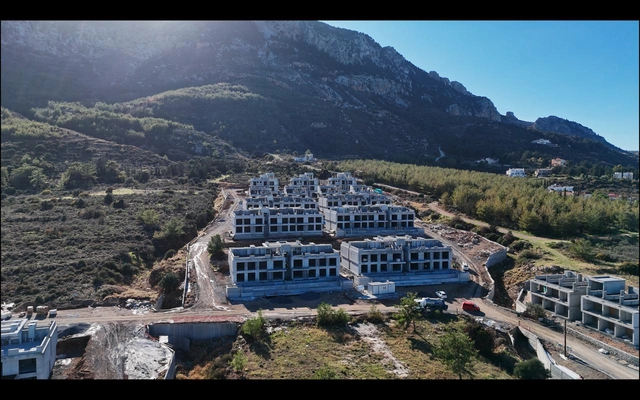 spectra drone (7).jpeg7 Modern 1-bedroom garden apartment in Spectra Project Lapta featuring stylish interior design, open-plan kitchen, spacious living area, and scenic mountain and pool views in North Cyprus.